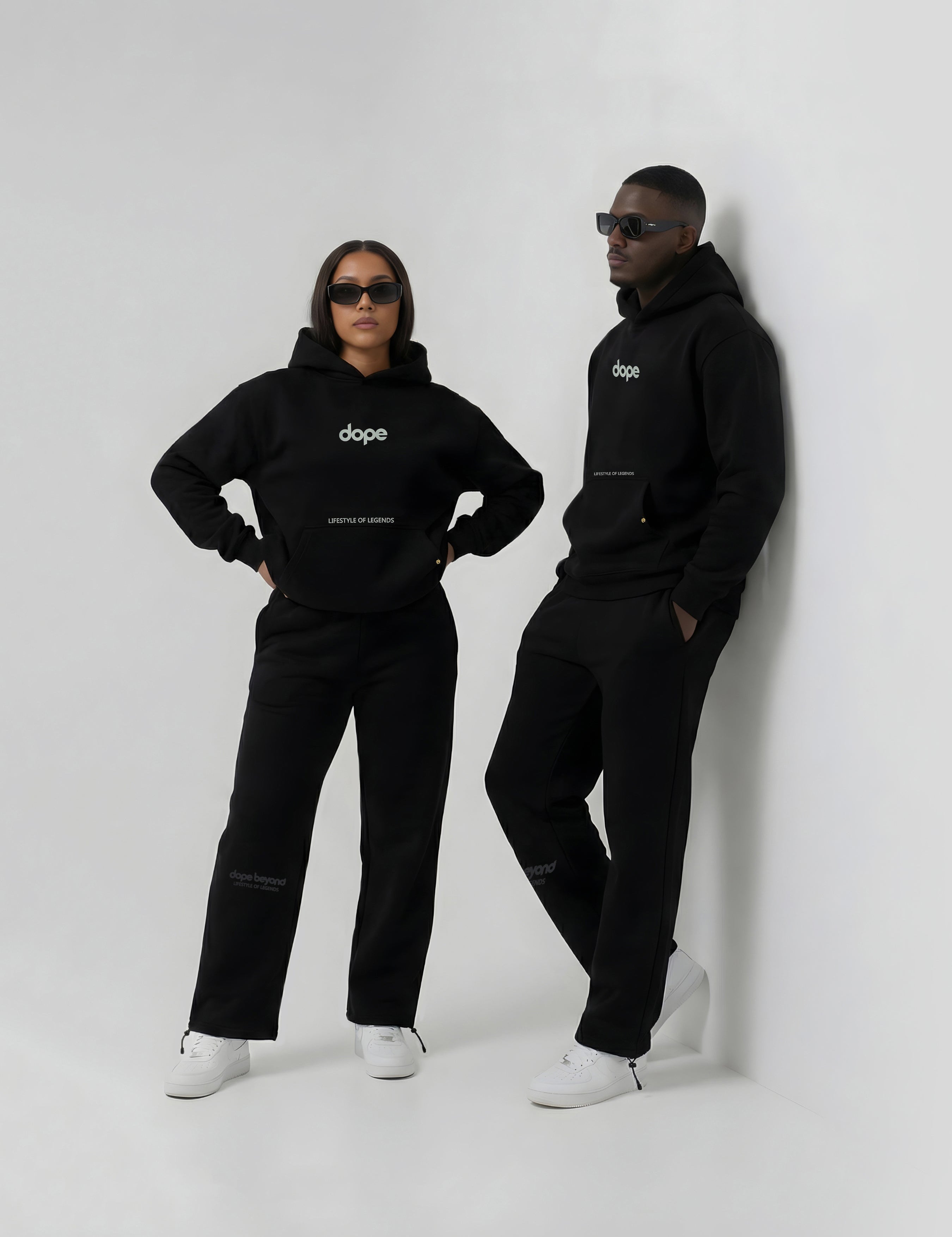 Two models in black heavyweight hoodies and joggers by Dope Beyond
