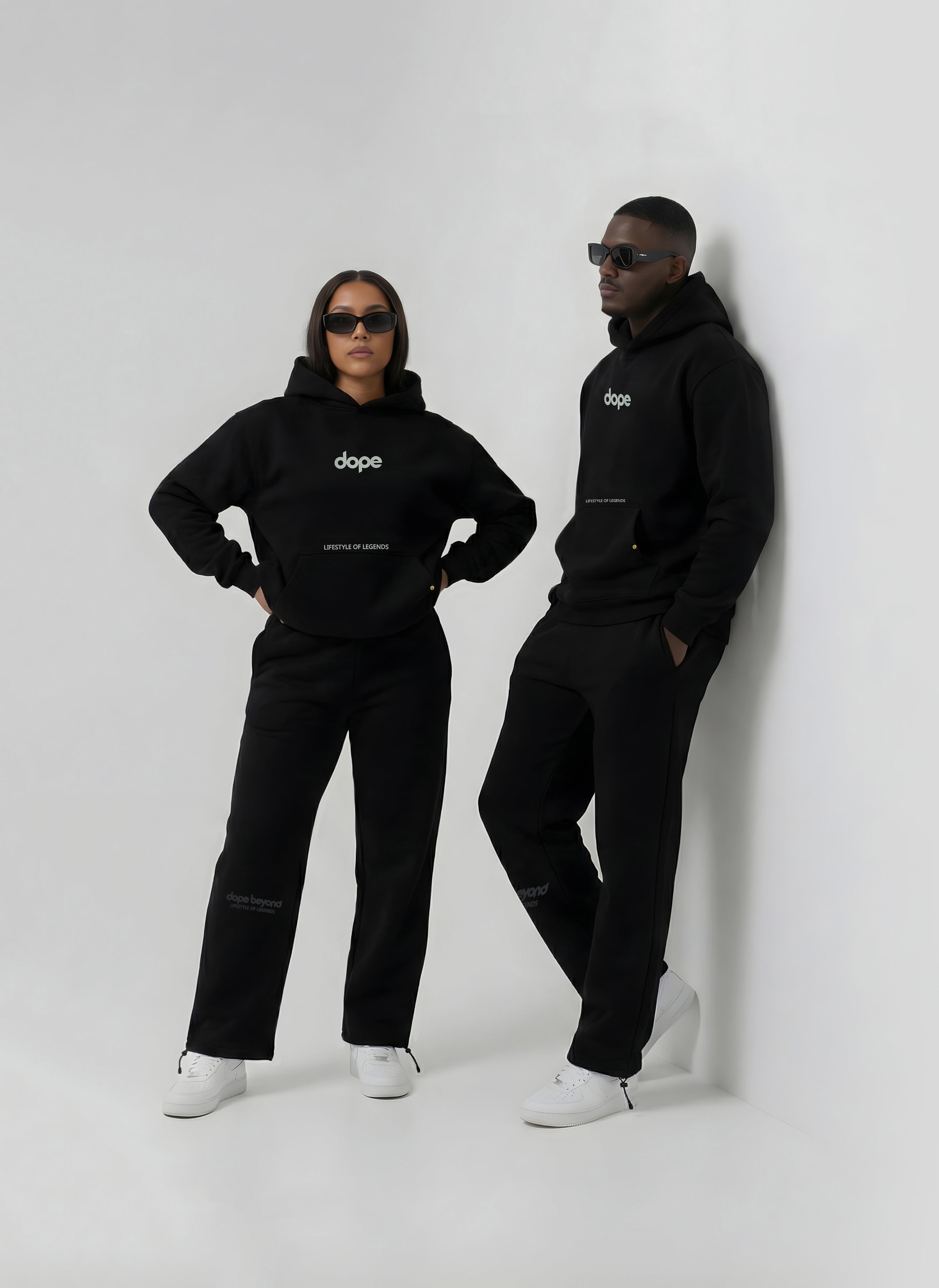 Two models in black heavyweight hoodies and joggers by Dope Beyond
