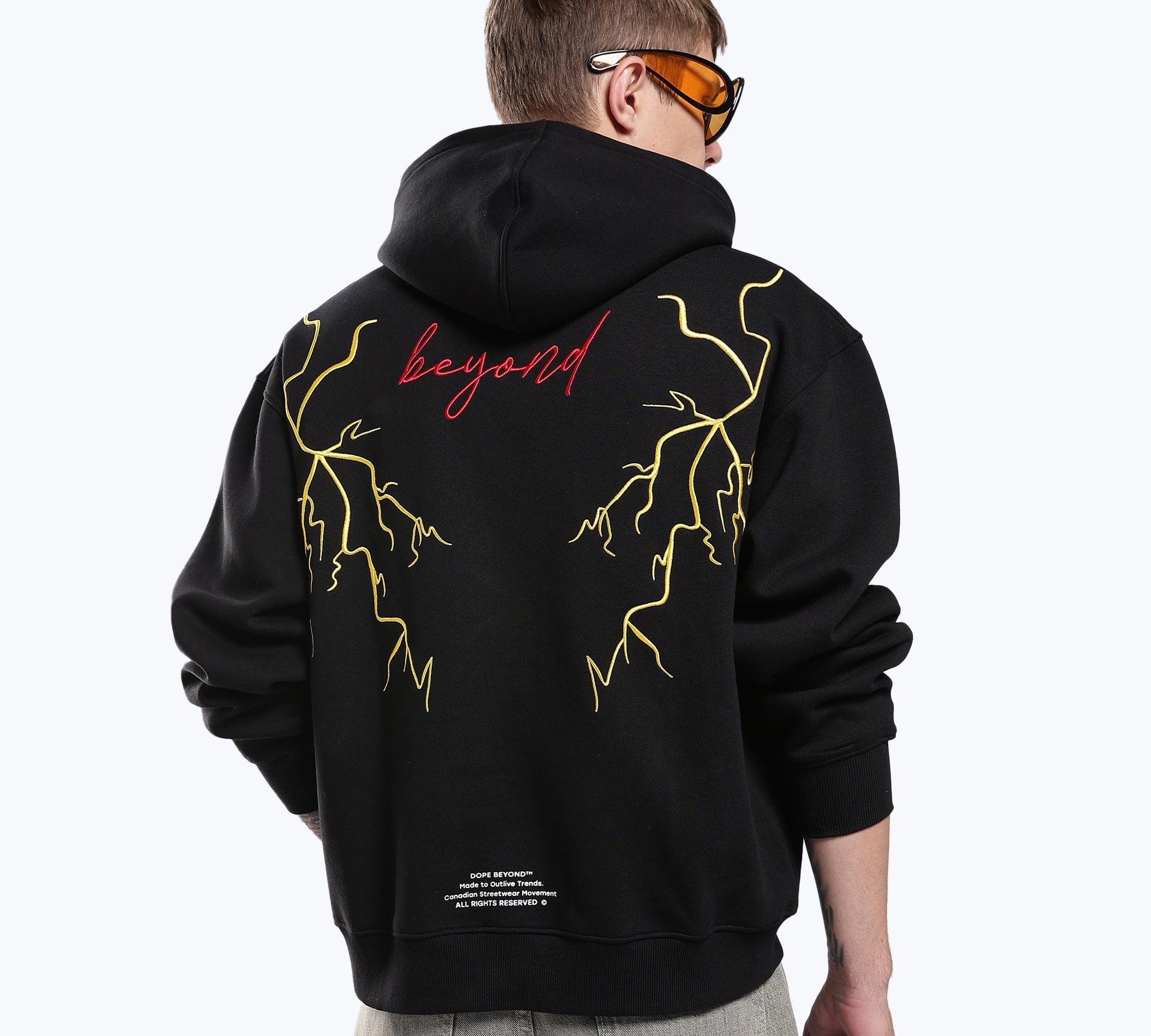 Black 777 lightning hoodie by Dope Beyond – back view on male model showing the embroidered lightning graphic