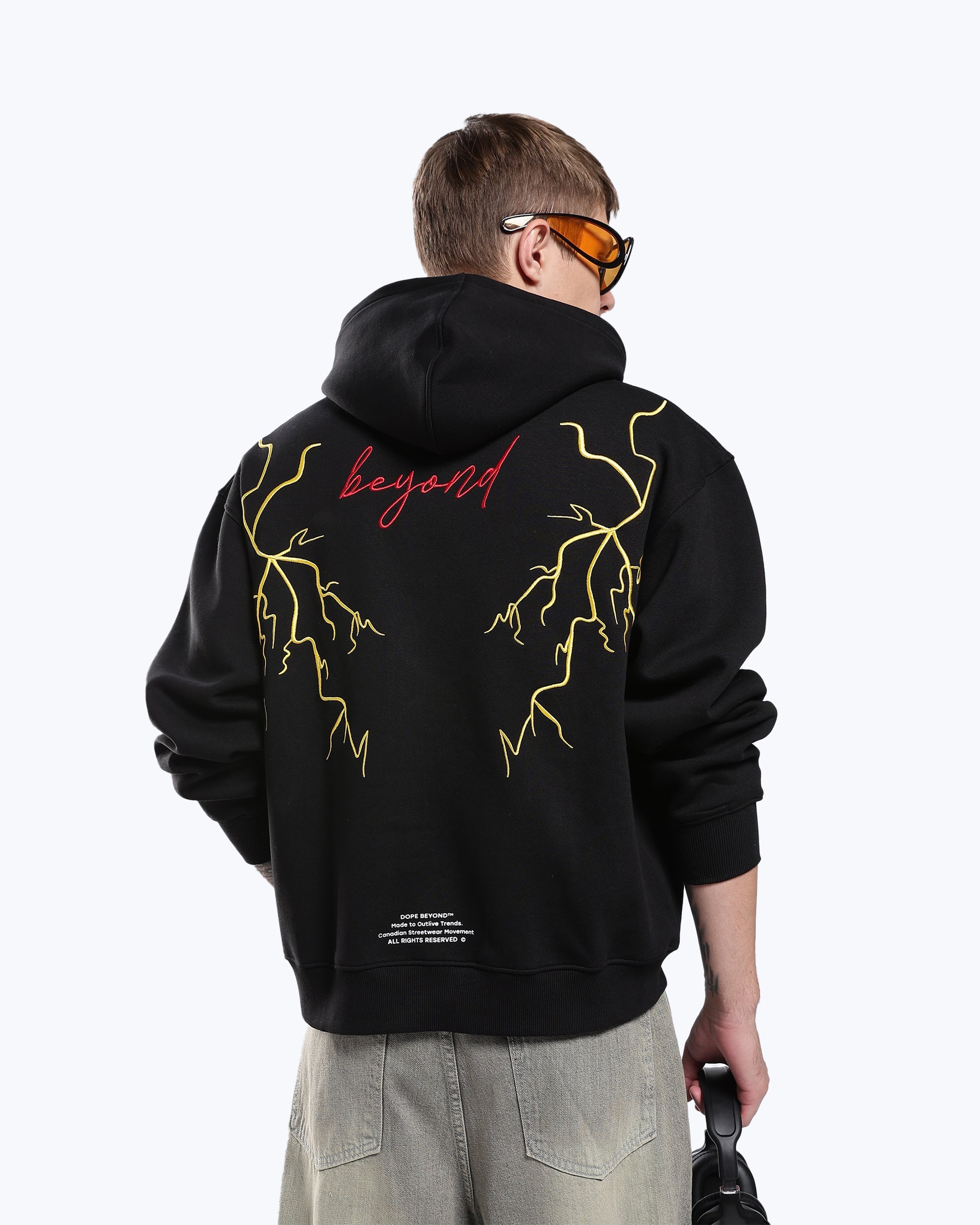 Black 777 lightning hoodie by Dope Beyond – back view on male model showing the embroidered lightning graphic