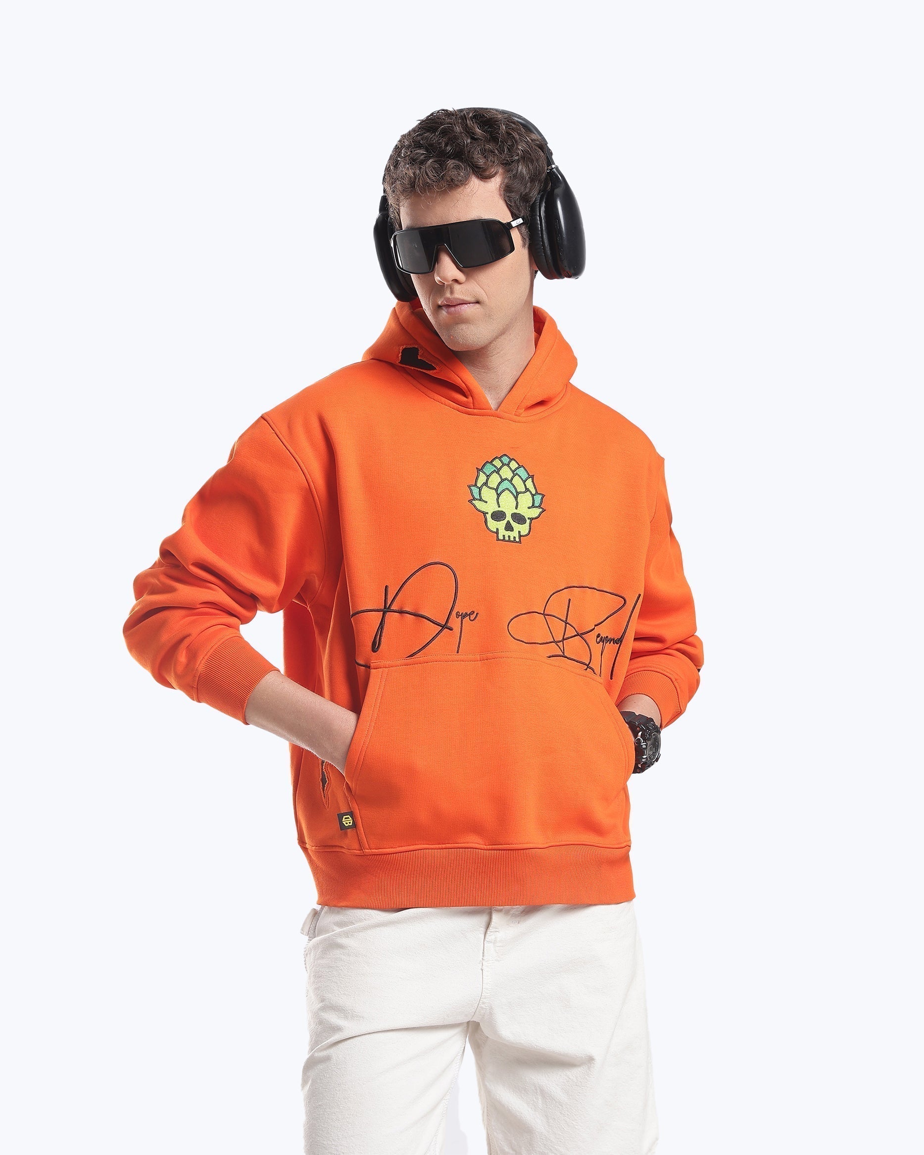 Model in the orange Skull in Bloom graphic heavyweight hoodie by Dope Beyond