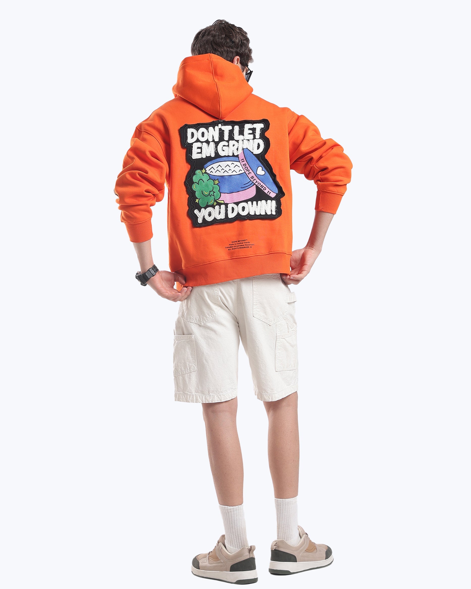 Orange Skull in Bloom hoodie by Dope Beyond, full-length back view showing the Don't Let Em Grind You Down patch