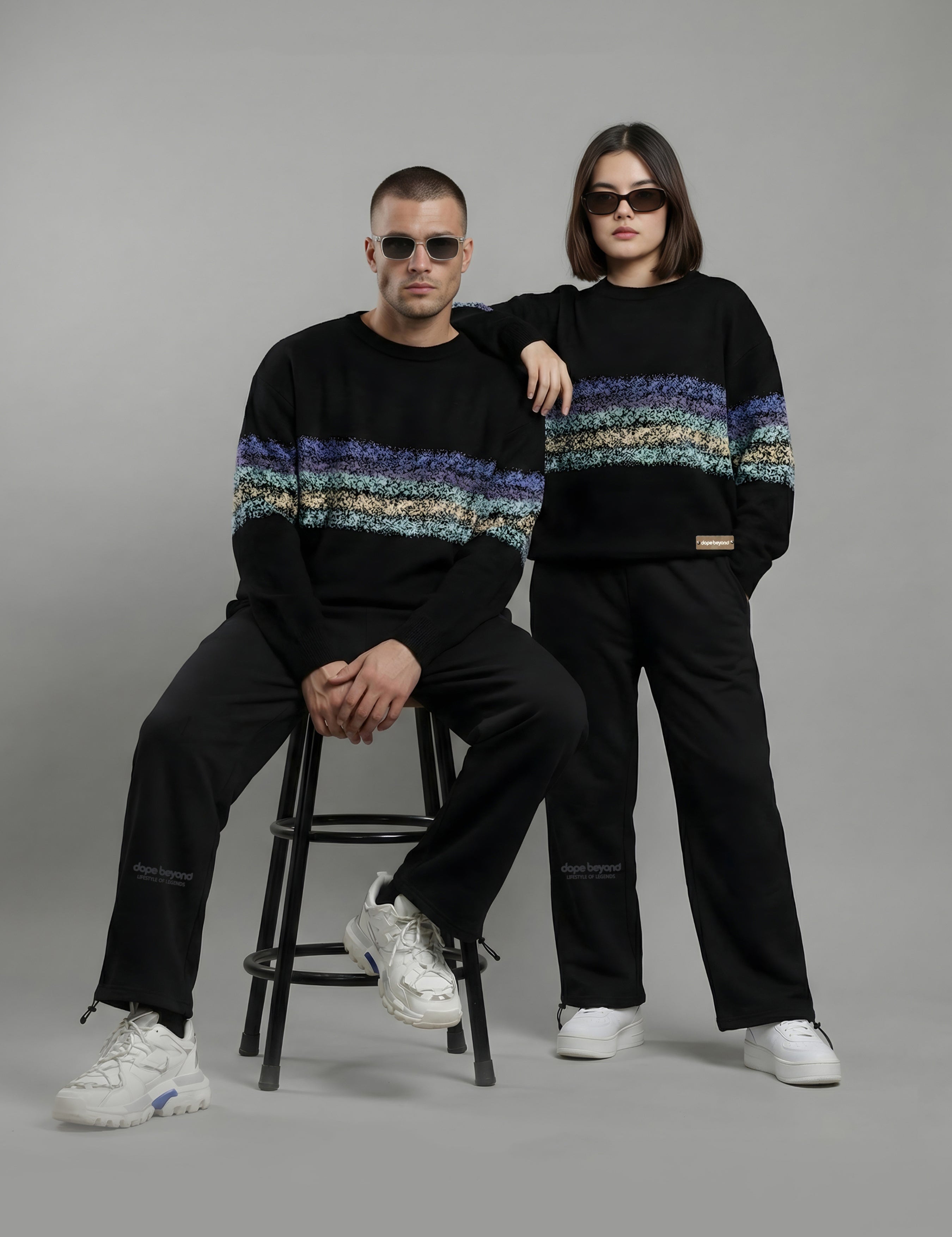 Two models in black Dope Beyond crewneck sweatshirts and joggers