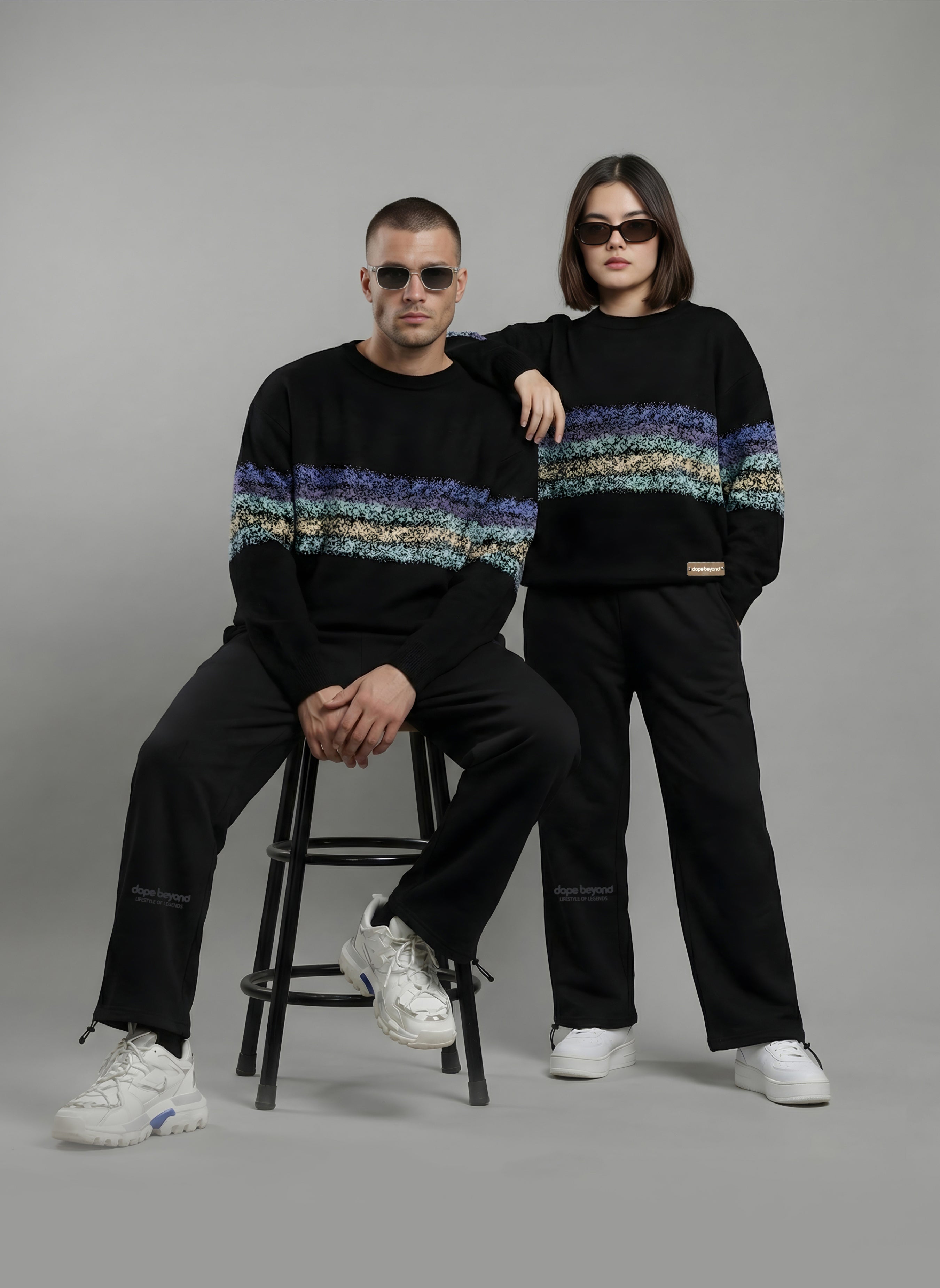 Two models in black Dope Beyond crewneck sweatshirts and joggers