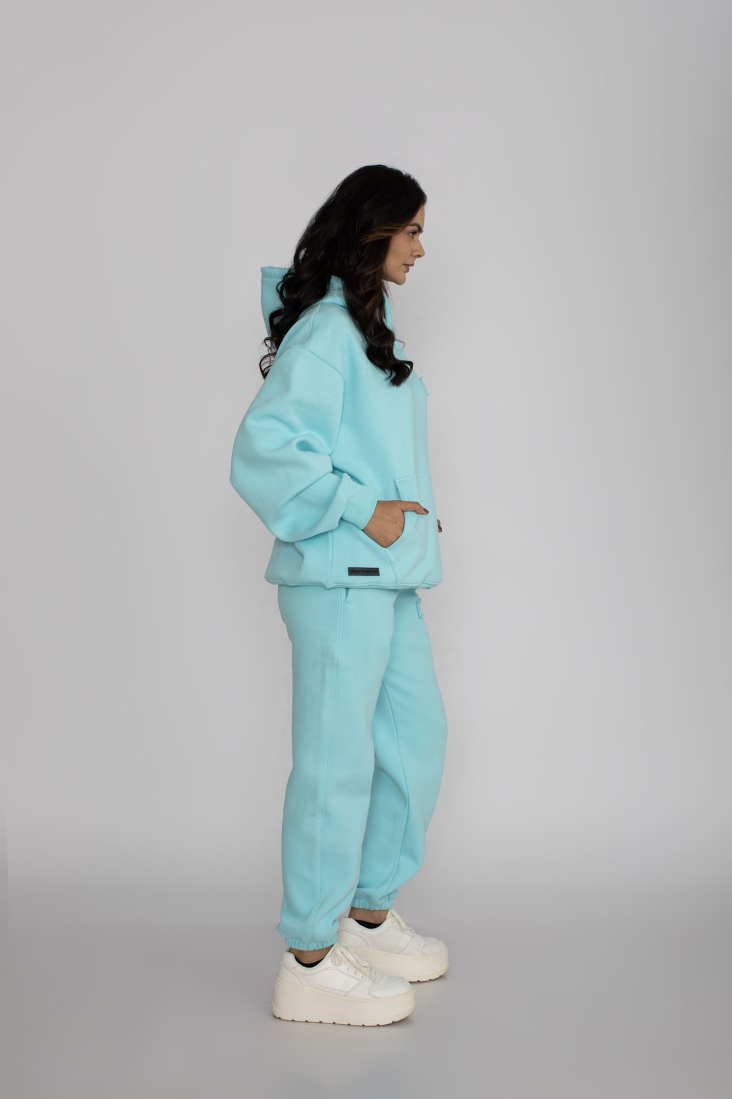 Model in a mint green matching heavyweight hoodie and joggers set by Dope Beyond