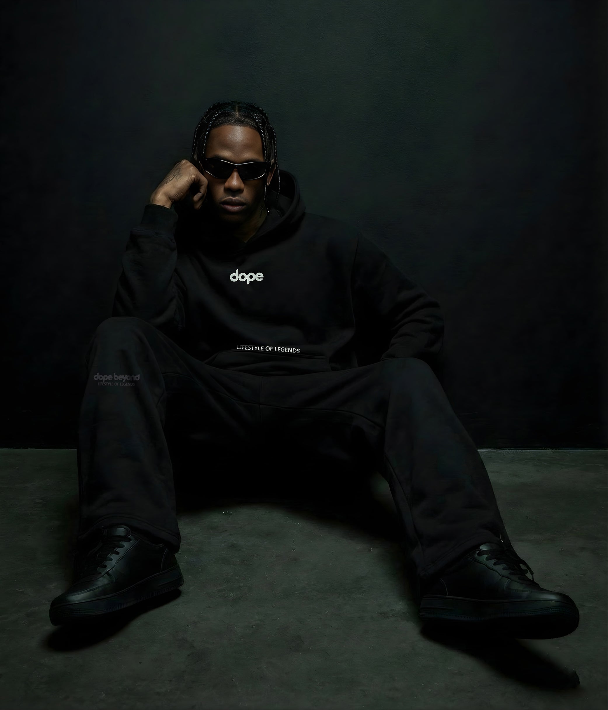 Model in an all-black Dope Beyond hoodie and joggers streetwear outfit