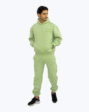 Man wearing light green dopebeyond streetwear hoodie and joggers set, casual style
