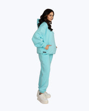 Woman wearing light blue streetwear hoodie and sweatpants, dopebeyond high-frequency apparel