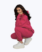 Woman in bright pink streetwear hoodie and joggers, white platform sneakers, dopebeyond style