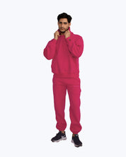 Man modeling bright pink dopebeyond streetwear tracksuit with logo joggers and hoodie.