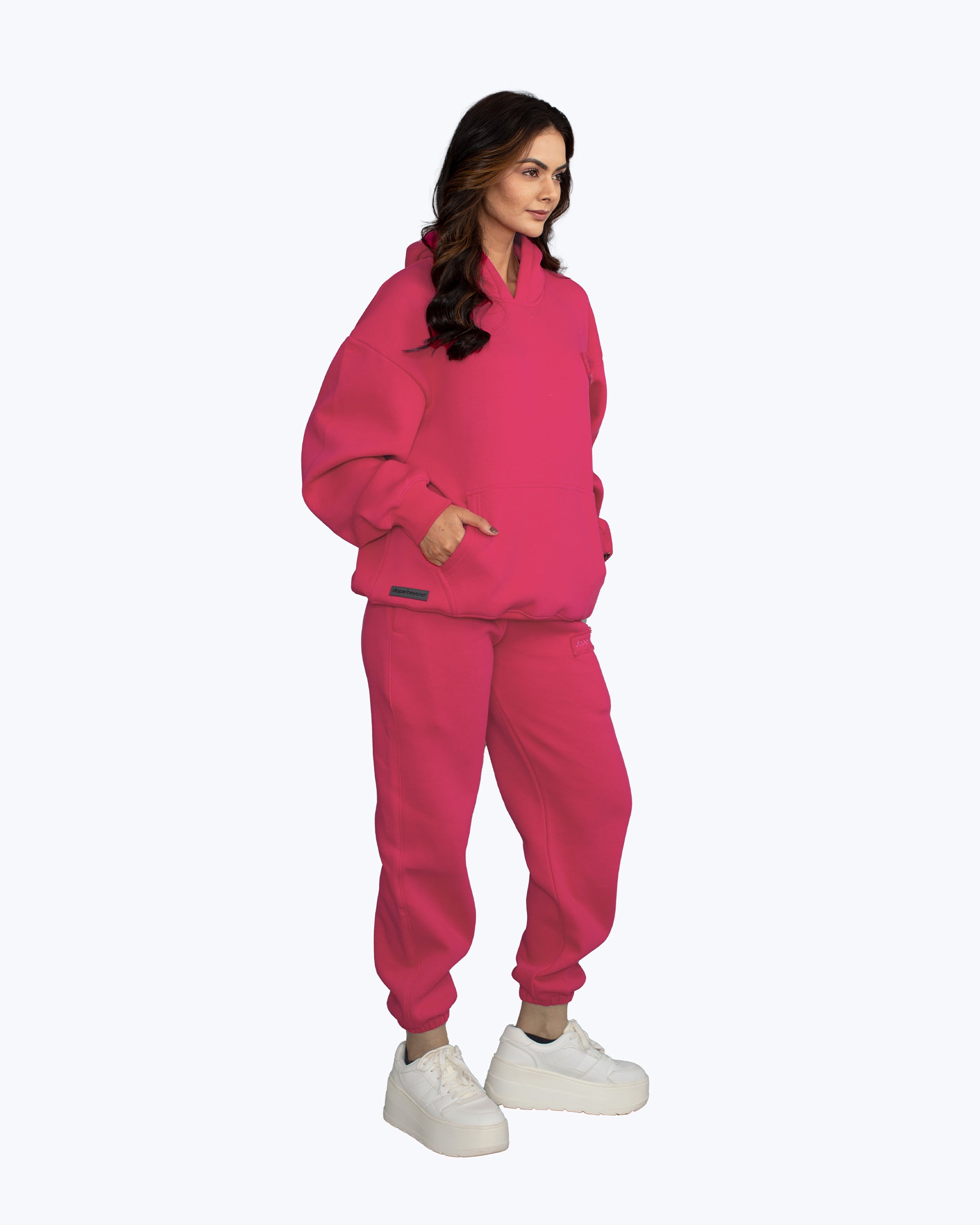 Woman in bright pink streetwear hoodie and joggers, dopebeyond high-frequency apparel