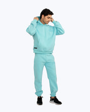 Man wearing light blue matching hoodie and sweatpants streetwear set by DOPE BEYOND