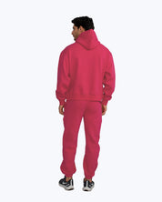 Man wearing pink streetwear hoodie and joggers set by dopebeyond, rear view