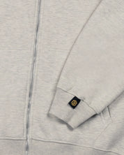 Close-up of Dope Beyond heavyweight ecru melange hoodie sleeve with logo tag and zipper