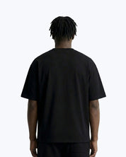 Back view of dopebeyond streetwear black t-shirt on male model against white background