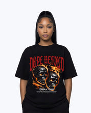 Woman wearing Dope Beyond black graphic streetwear t-shirt with flaming skulls and bold red lettering.