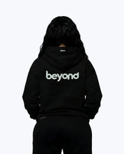 Back view of black Dope Beyond hoodie with bold 'beyond' white puff print, streetwear style