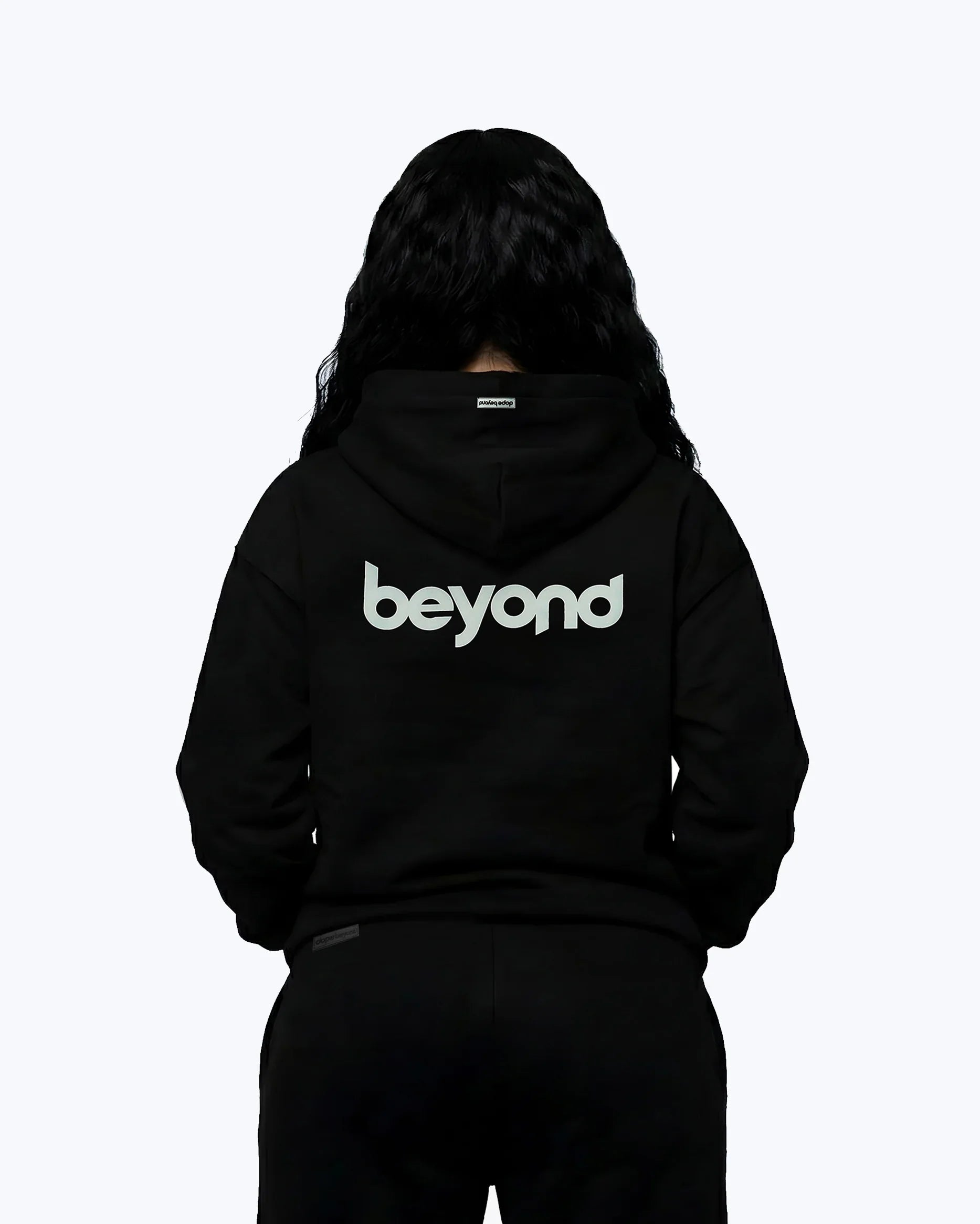 Back view of black Dope Beyond hoodie with bold 'beyond' white puff print, streetwear style