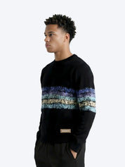 Man wearing Dope Beyond black streetwear sweatshirt with blue and beige stripe pattern