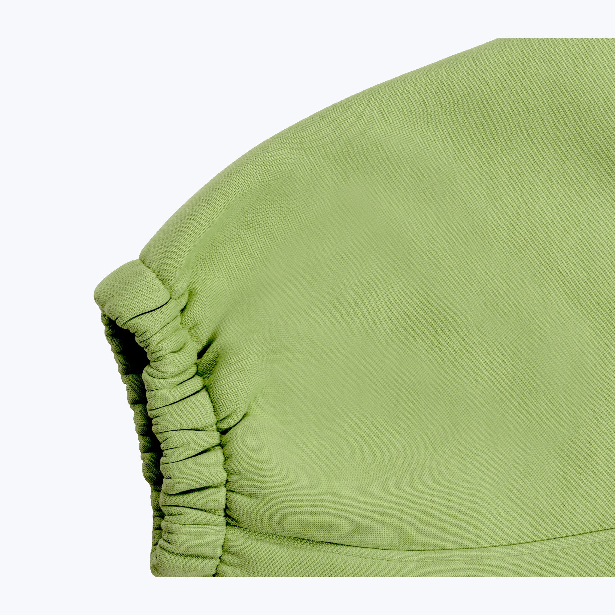 Green streetwear jogger pants with ruched detail, Dope Beyond apparel close-up