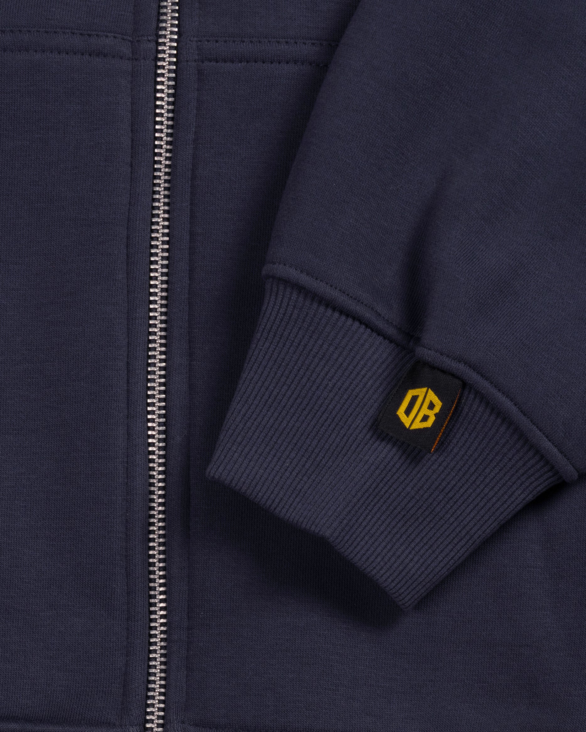 dopebeyond heavyweight hoodie sleeve detail with yellow DB tag and metal zipper
