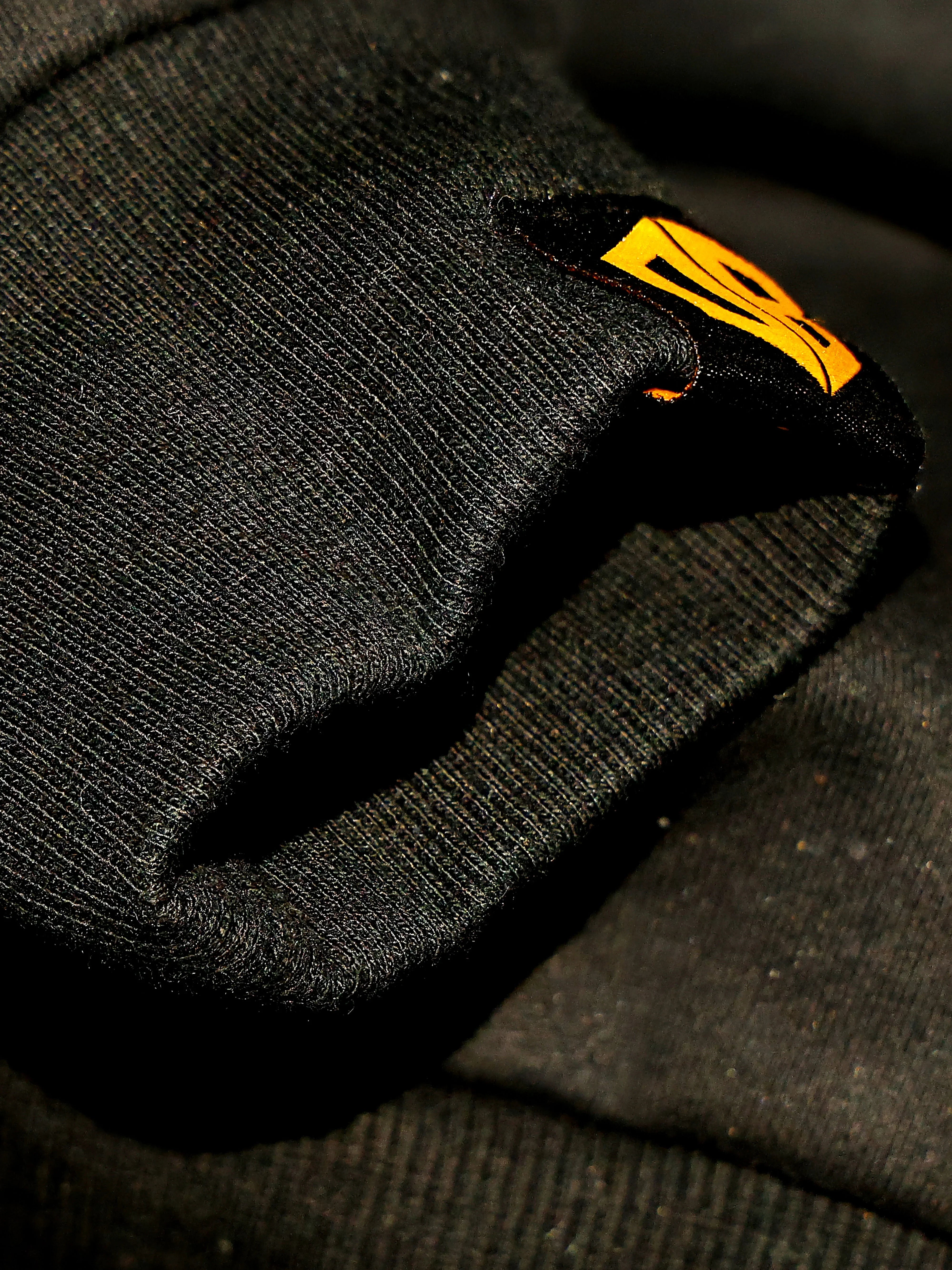Dope Beyond olive green gym hoodie close-up with yellow logo patch, streetwear detail