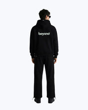 Male model wearing black Dope Beyond heavyweight streetwear cord set, back view, logo visible.