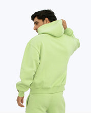 Man in light green hoodie and joggers, streetwear fashion by dopebeyond
