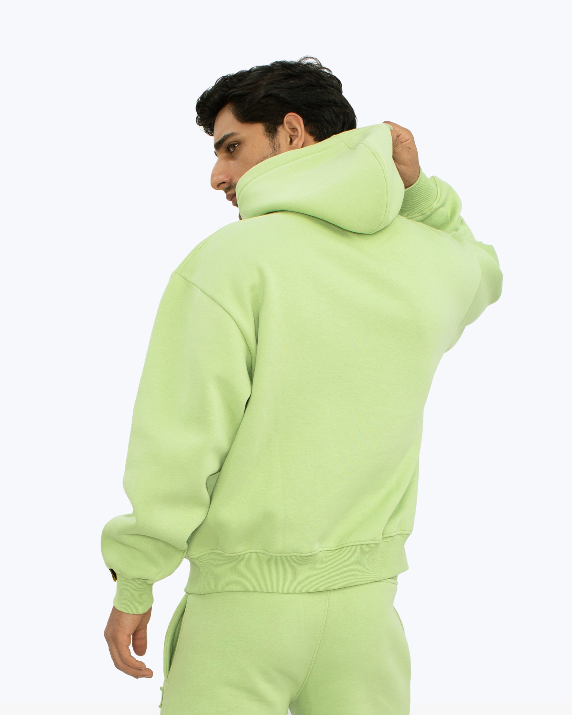 Man in light green hoodie and joggers, streetwear fashion by dopebeyond