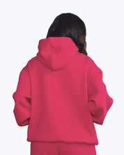 Back view of a woman wearing a vibrant pink streetwear hoodie from dopebeyond