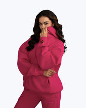 Woman wearing vibrant pink dopebeyond hoodie and sweatpants, streetwear fashion