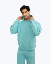 Man wearing light blue dopebeyond hoodie and sweatpants, streetwear fashion