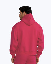 Man wearing vibrant pink streetwear hoodie and matching pants, dopebeyond apparel