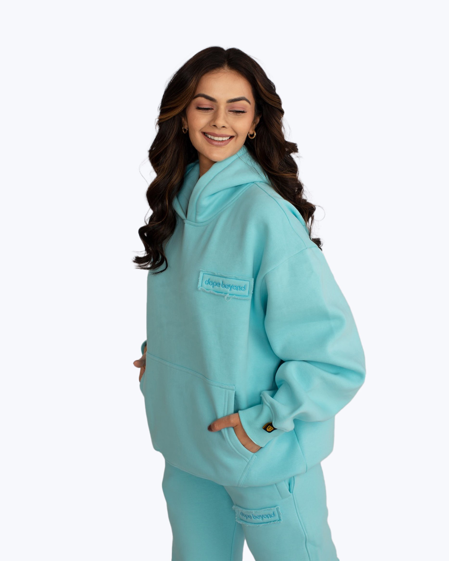 Woman wearing light blue dopebeyond hoodie and joggers, streetwear fashion apparel