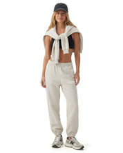 Ecru melange Signature heavyweight joggers by Dope Beyond – front view on female model with the zip hoodie over her shoulders