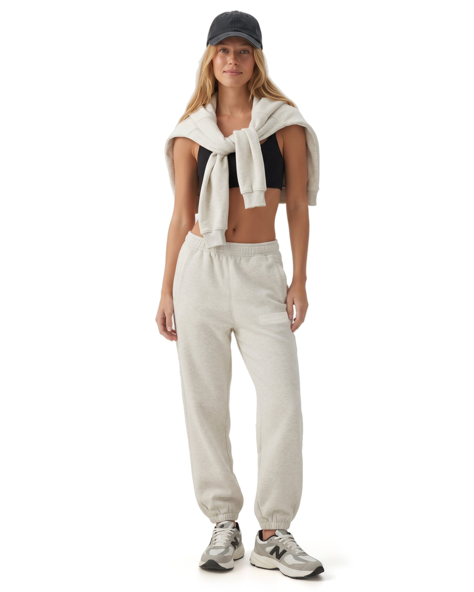 Ecru melange Signature heavyweight joggers by Dope Beyond – front view on female model with the zip hoodie over her shoulders