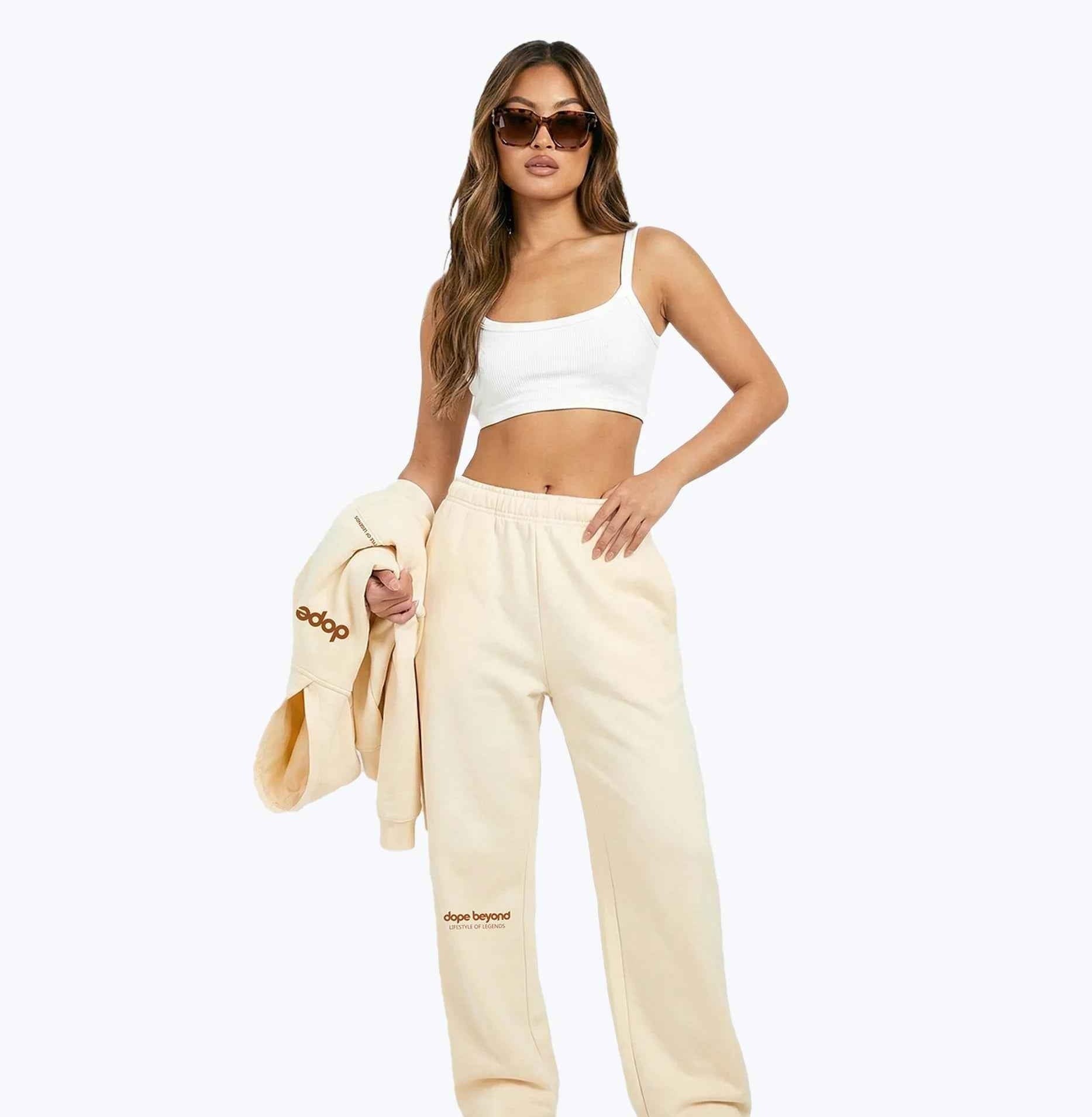 Beige Legends heavyweight joggers by Dope Beyond – front view on female model holding the matching hoodie
