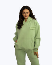 Woman wearing mint green dopebeyond streetwear hoodie and sweatpants set