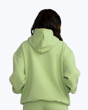 Back view of person in mint green streetwear hoodie and pants, dopebeyond style
