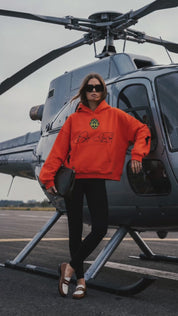 Orange Skull in Bloom heavyweight hoodie by Dope Beyond – video on female model by a helicopter